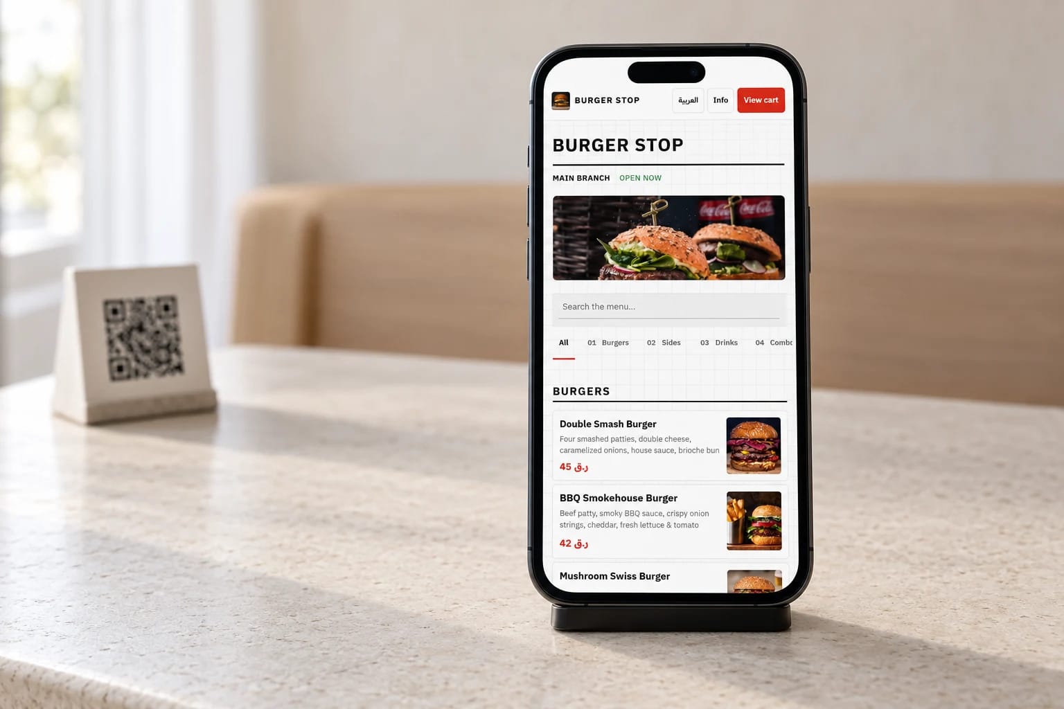 Real DashDine English menu on a guest’s phone beside a QR stand in an illustrative restaurant setting