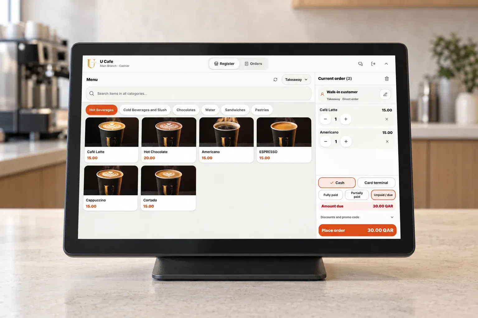 Actual DashDine POS interface with a sample coffee order on a counter display in an illustrative café scene