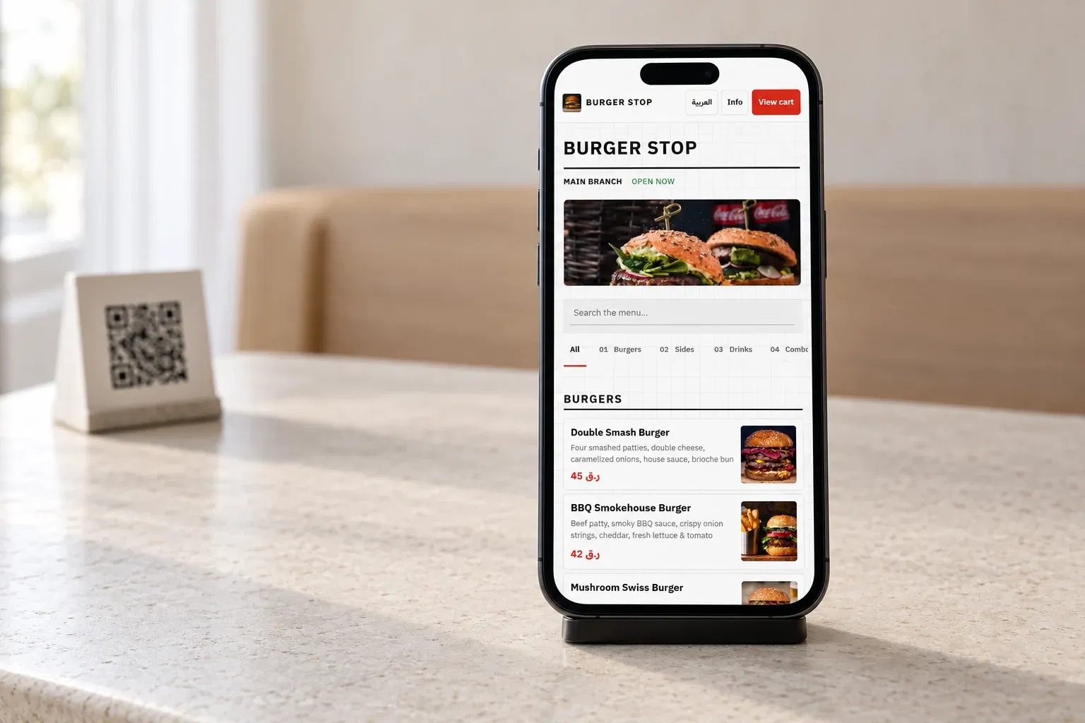 Real DashDine English menu on a guest’s phone beside a QR stand in an illustrative restaurant setting